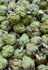 Fresh green artichokes background, closeup, advertising for healthy food and organic farming