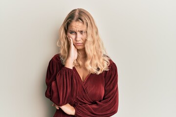 Young blonde girl wearing casual clothes thinking looking tired and bored with depression problems with crossed arms.