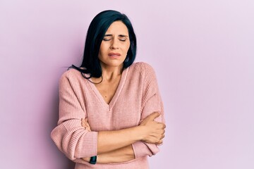 Fototapeta premium Young caucasian woman wearing casual clothes shaking and freezing for winter cold with sad and shock expression on face
