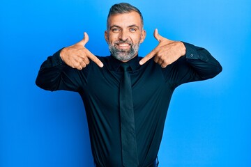 Middle age handsome man wearing business shirt and tie looking confident with smile on face,...