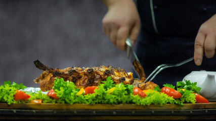 Chef carves a dish of poultry and vegetables