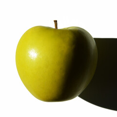 A green ripe apple with a shadow on a white background. Fresh fruit, proper nutrition.