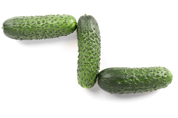 three green fresh cucumbers isolated on white background.