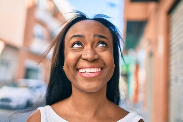 Young african american woman smiling happy walking at the city.