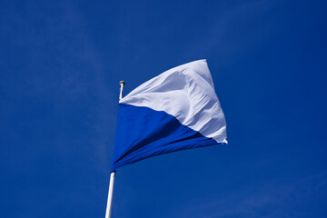 Flag of city and canton Zurich, Switzerland, blowing in the wind