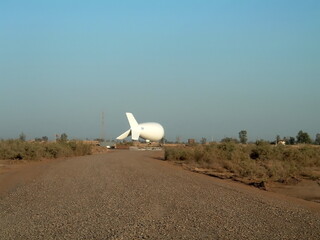 Aerostat surveillance balloon docked in a field over Camp Taji, outside of Baghdad, Iraq, during the war