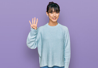 Young hispanic woman wearing casual clothes showing and pointing up with fingers number four while smiling confident and happy.