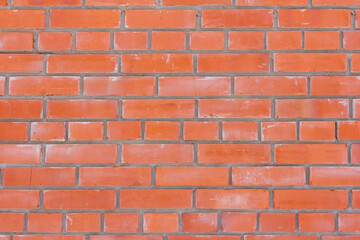 Red brick brick wall.Brick wall background with cement stains.