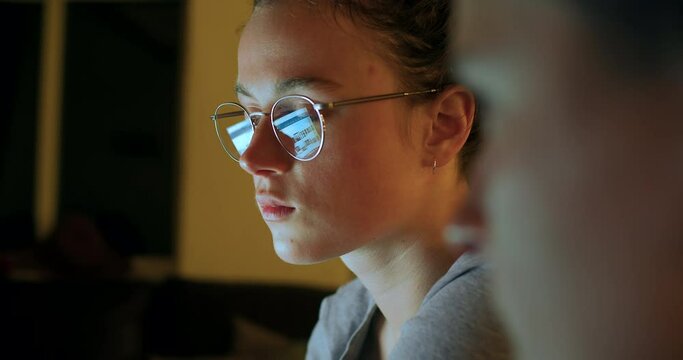 Two women work together on project. Reflection in glasses of computer or laptop screen. Big data analysis and blockchain cryptocurrency investement. Female IT engineer writes code for backend