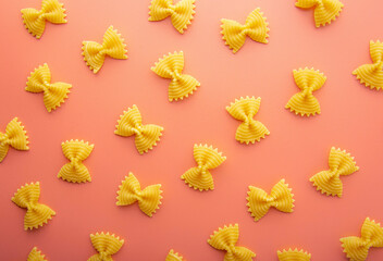Pasta farfalle on pink background
