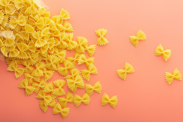 Pasta farfalle on pink background