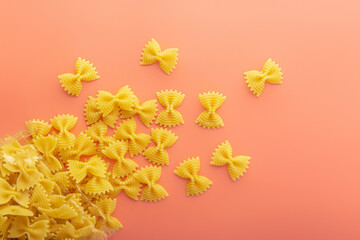 Pasta farfalle on pink background