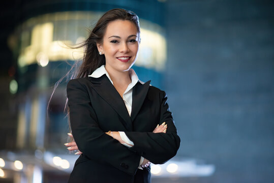 Businesswoman portrait in a modern city setting at night