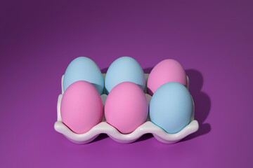 Easter eggs in a basket on a pink background