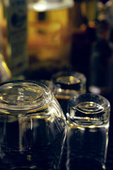 Empty alcohol glasses in front of blurry background
