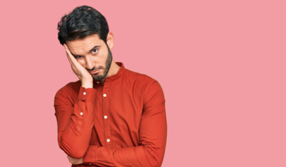 Fototapeta premium Young hispanic man wearing casual clothes thinking looking tired and bored with depression problems with crossed arms.