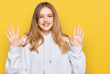 Beautiful young caucasian girl wearing casual sweatshirt showing and pointing up with fingers number ten while smiling confident and happy.