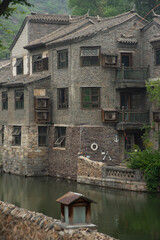 Fototapeta na wymiar Small and touristic medieval european village on the bank of a river