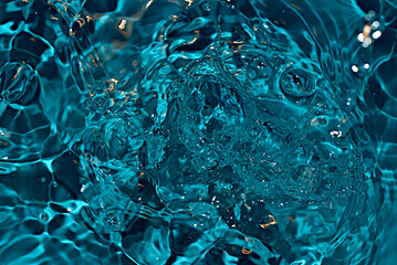 A snapshot of bubbling blue water and drops. High quality photo