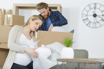 young couple moving to new flat with fragile possessions