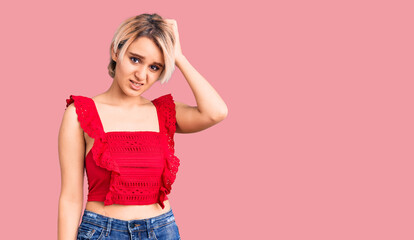Young beautiful blonde woman wearing casual clothes confuse and wonder about question. uncertain...