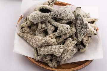 Crispy dried seaweed isolated on wooden plate.