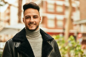 Fototapeta premium Young arab man smiling happy standing at the city.