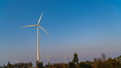 Windmill turbine generating electricity on blue sky 