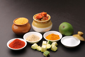 Fototapeta na wymiar Homemade Mango Pickle or aam ka achar Kairi Loncha with Ingredients.