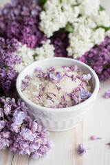 Obraz na płótnie Canvas Homemade bath salt with fresh spring lilac flowers, home healthy spa, relaxation, light wooden background, vertical