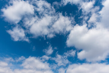 Naklejka na ściany i meble Beautiful blue sky with fluffy white clouds. Sky backgrounds.