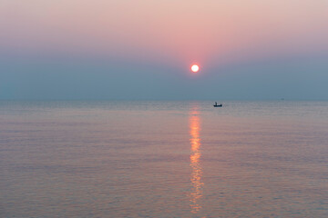 Amazing sunset over the beach. The sun rises over sea.  Pastel tone