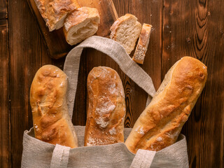 Baguettes In A Bag On Wooden Background