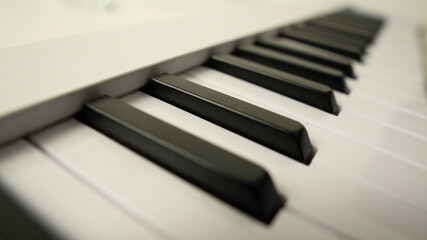 Piano keyboard background with selective focus. Warm color toned image