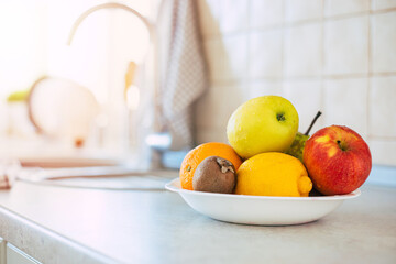 Fresh and ripe fruits composition on the table in the domestic kitchen