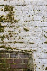 Background weathered brick wall with white plastering