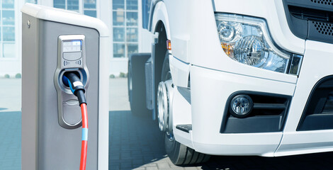 Electric vehicles charging station on a background of a truck. Concept  © scharfsinn86