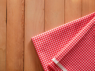 Fototapeta premium Classic pink plaid fabric or tablecloth on wood desk with copy space