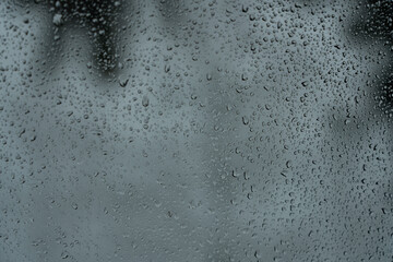 Beautiful raindrops on misted glass