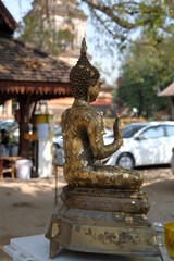 The Buddha image covered with gold leaf, according to Thai beliefs.  Side view