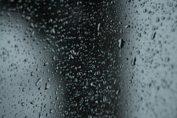 Beautiful raindrops on misted glass