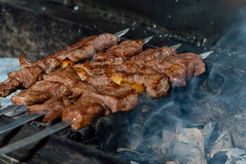 beef kebab wrapped on charcoal. juicy barbecue beef steaks are cooked in a restaurant over an open fire
