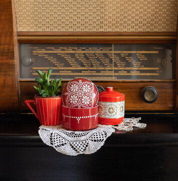 Red Home Decor Items, Boxes And A Cup As A Succulent Pot - On A Piano, Before A Vintage Radio