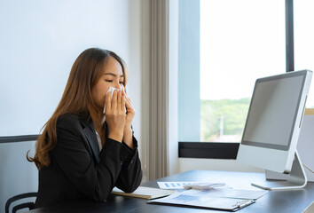 A young accountant, a beautiful woman, is sick and has a cold, so works at home by chatting over a videoconference with a co-worker. For social spacing, business meeting ideas