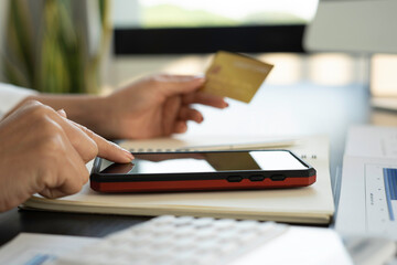 Women hand using mobile smartphone payments and credit card for online shopping mobile banking, Online shopping, digital banking, internet payment concept.