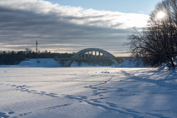 Railroad bridge over freezed river in snow