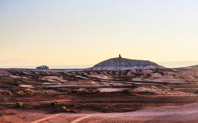 Human silhouette sitting on the hill, meditation in the nature, Martian landscape 