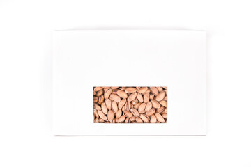 Roasted salted pistachios in a sealed box on a white background