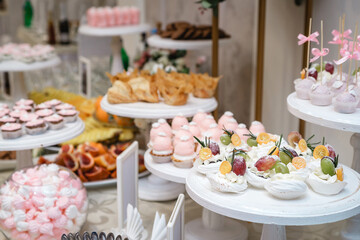 Dessert table for a party. Ombre cake, cupcakes, sweetness.