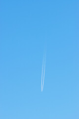Plane with trace on a clear blue sky